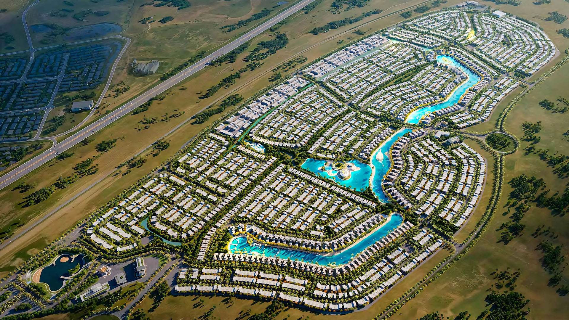 Aerial view of a massive residential master community with numerous villas organized around a large, winding blue lagoon.