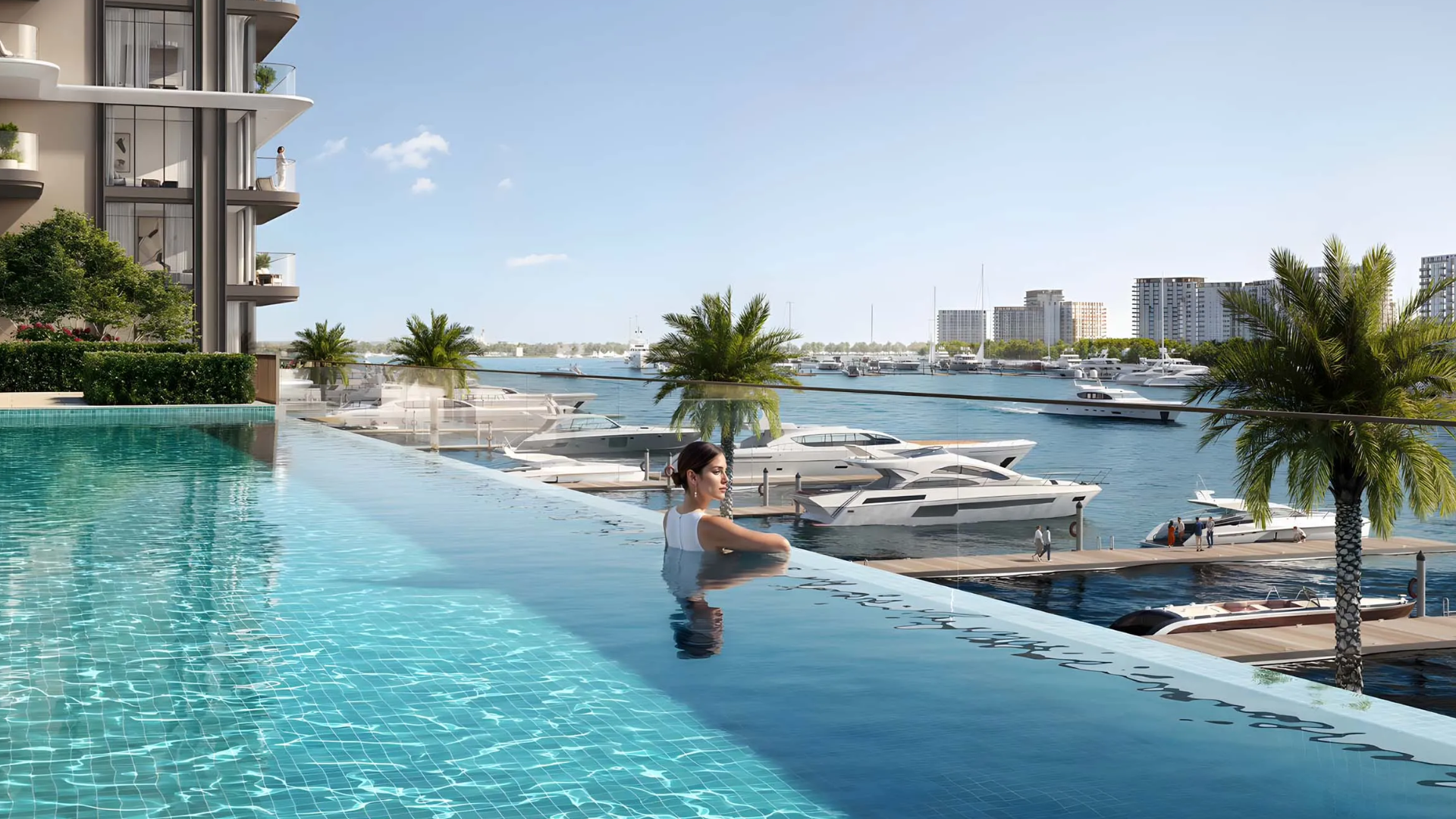 Infinity pool overlooking a vast body of water filled with luxury yachts .