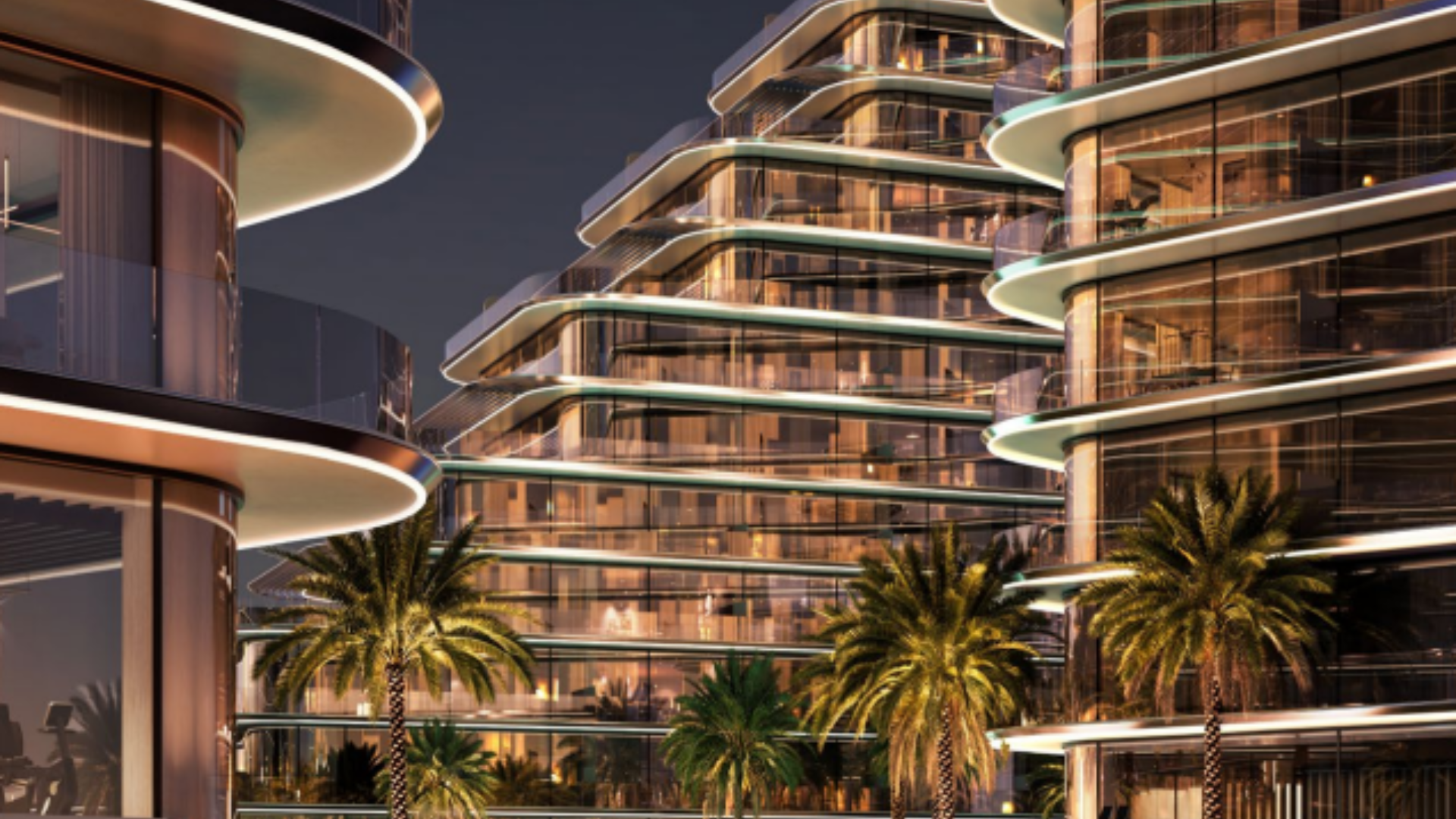 Curved glass residential towers with night lighting and palm trees