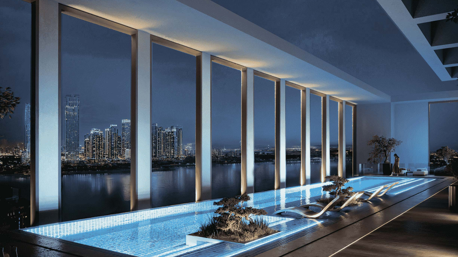 Stylish pool deck with scenic views of city skyscrapers at night