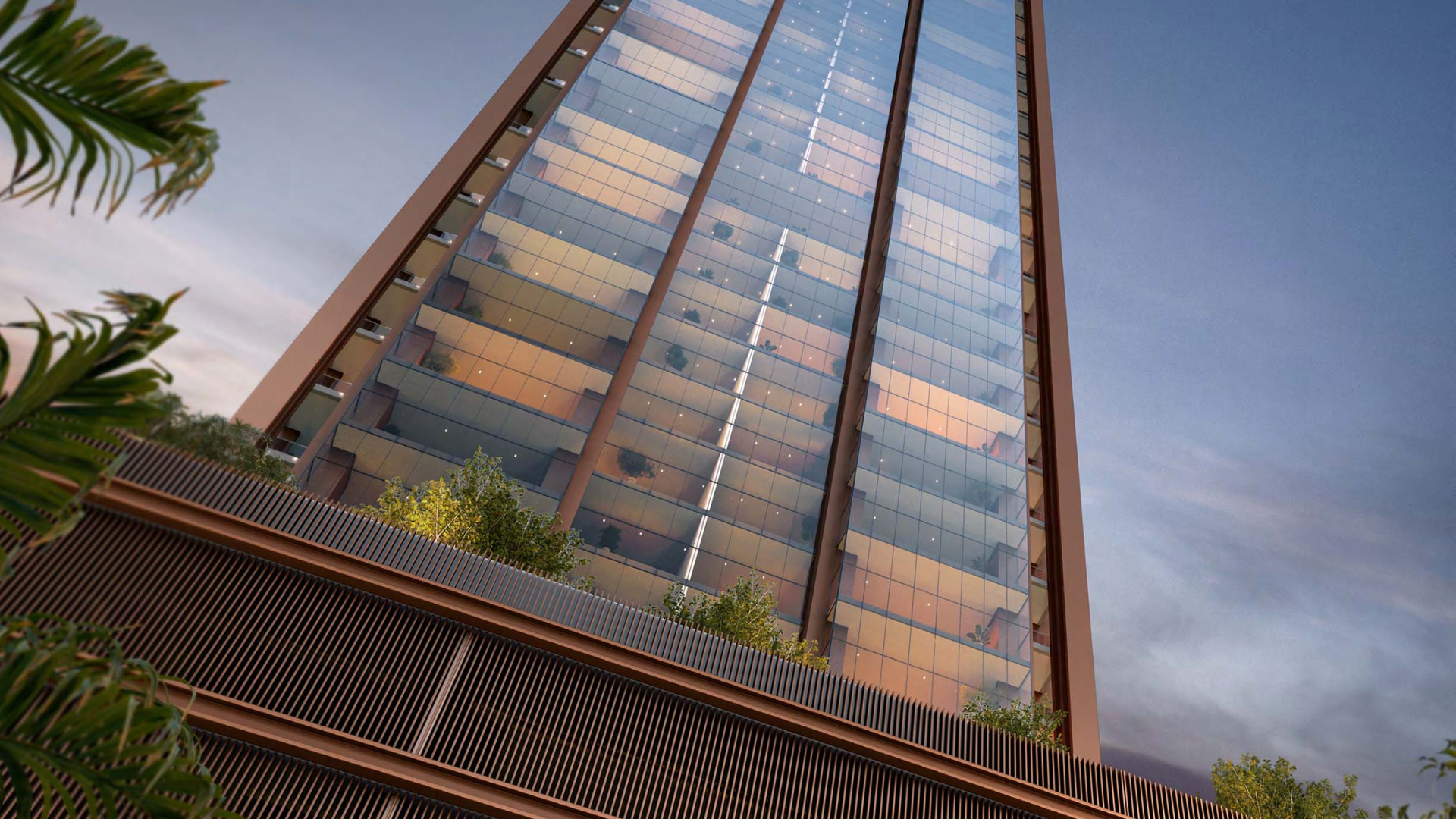 Glass tower with balcony greenery viewed against a twilight sky