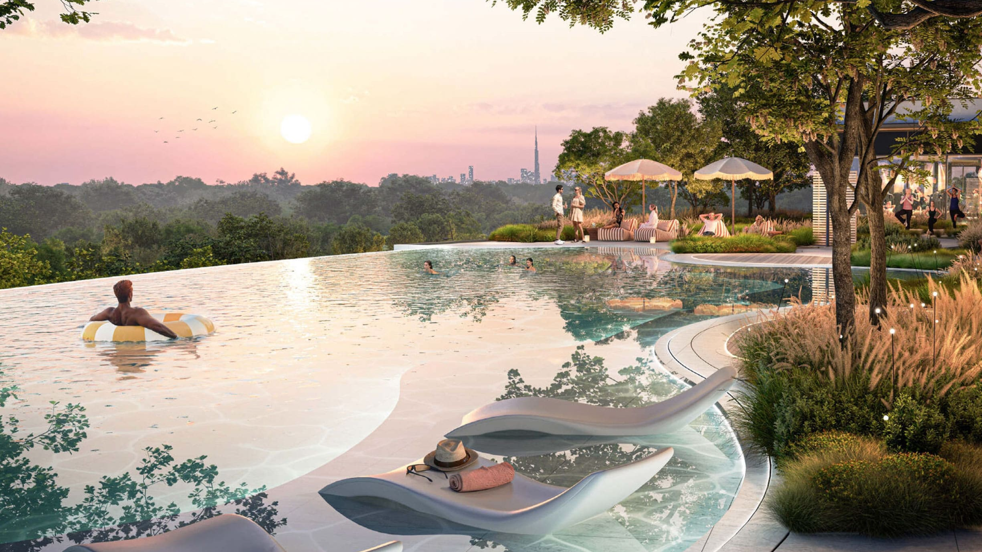 Infinity pool at sunset with lounge chairs, people swimming, and city skyline in the distance.