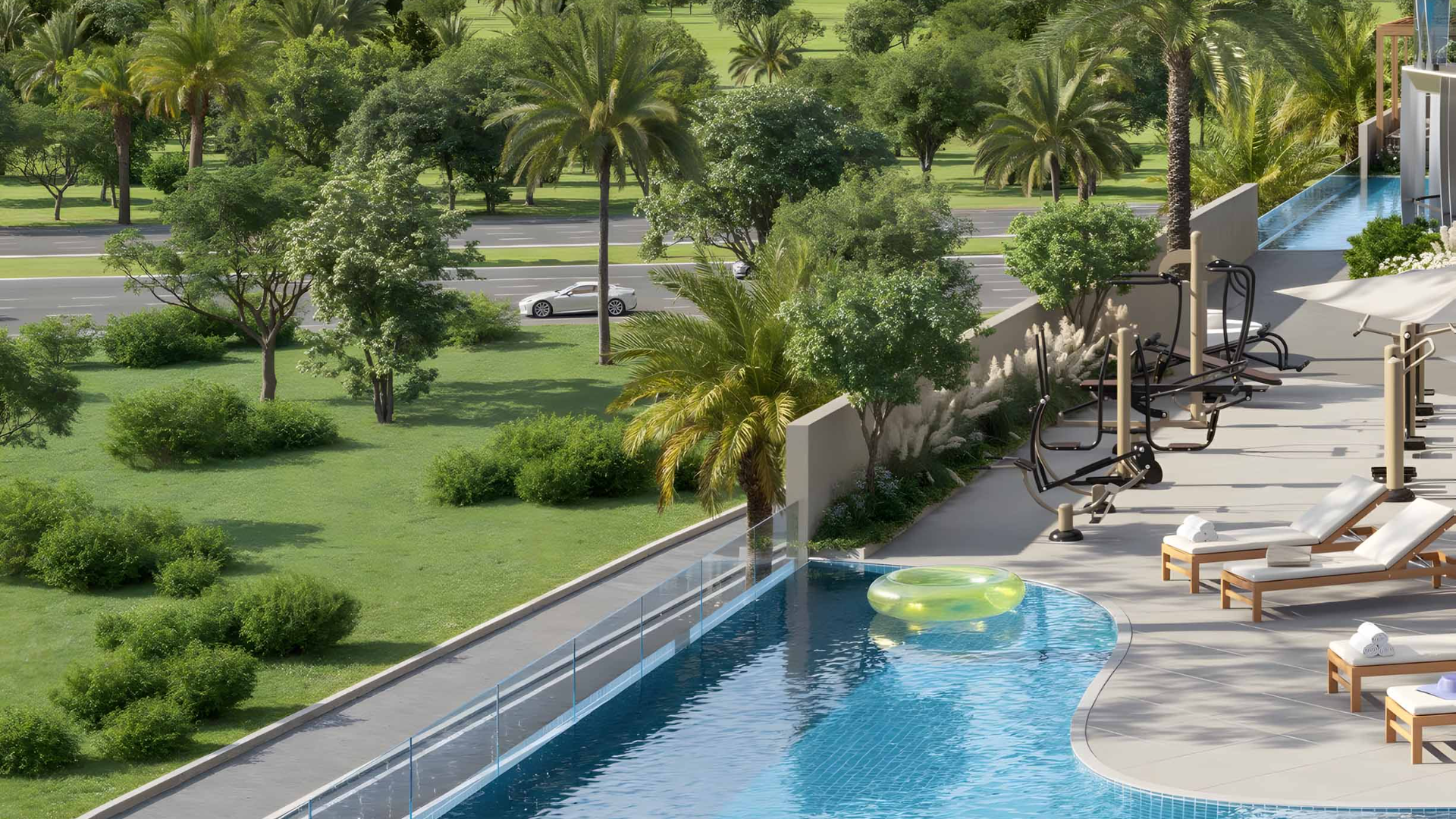 Outdoor swimming pool with loungers, gym equipment, and green landscape.