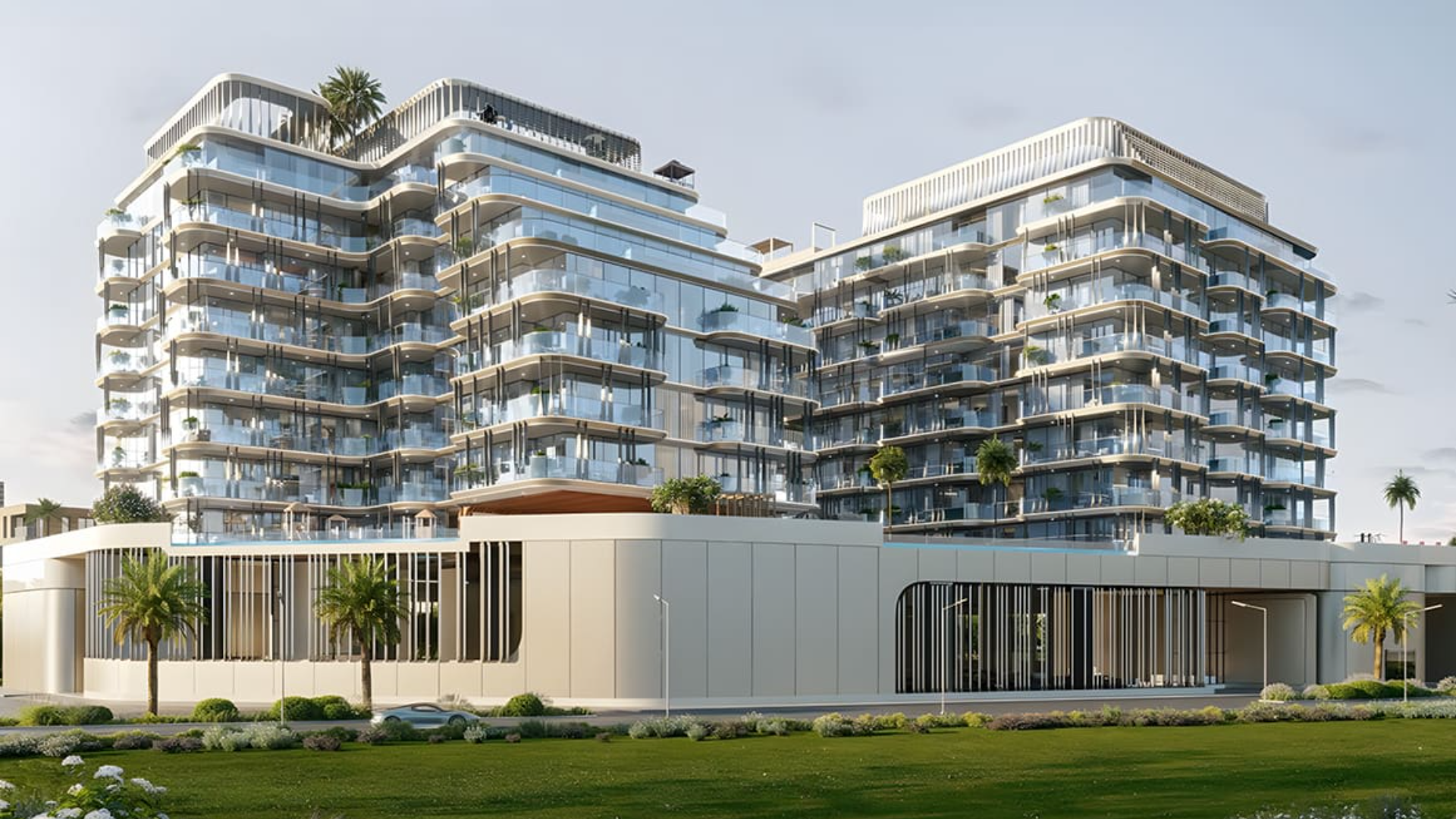 Modern building with curved balconies and glass front on a green street