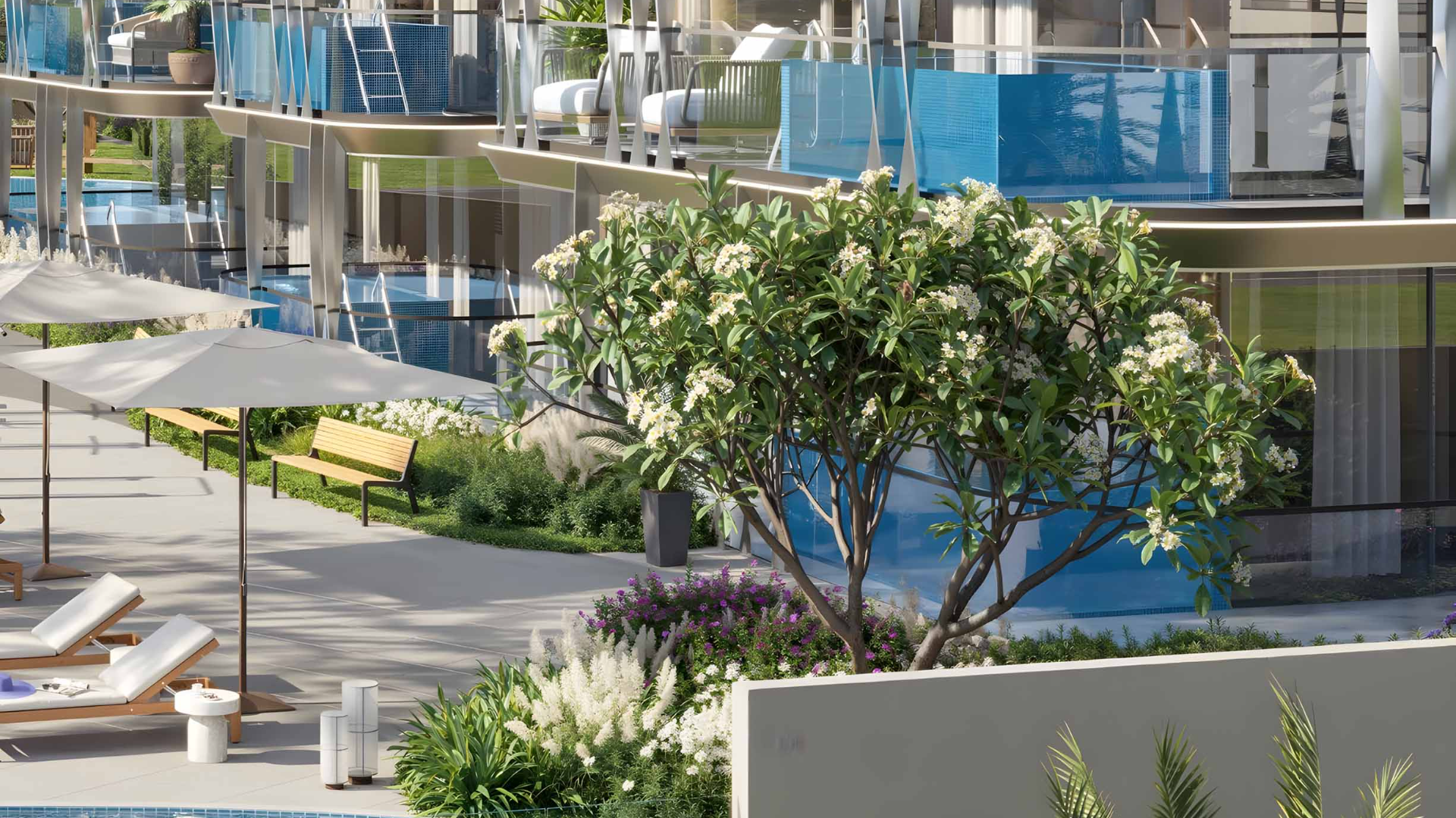 Outdoor lounge area with flowering trees, sun loungers, and pool.