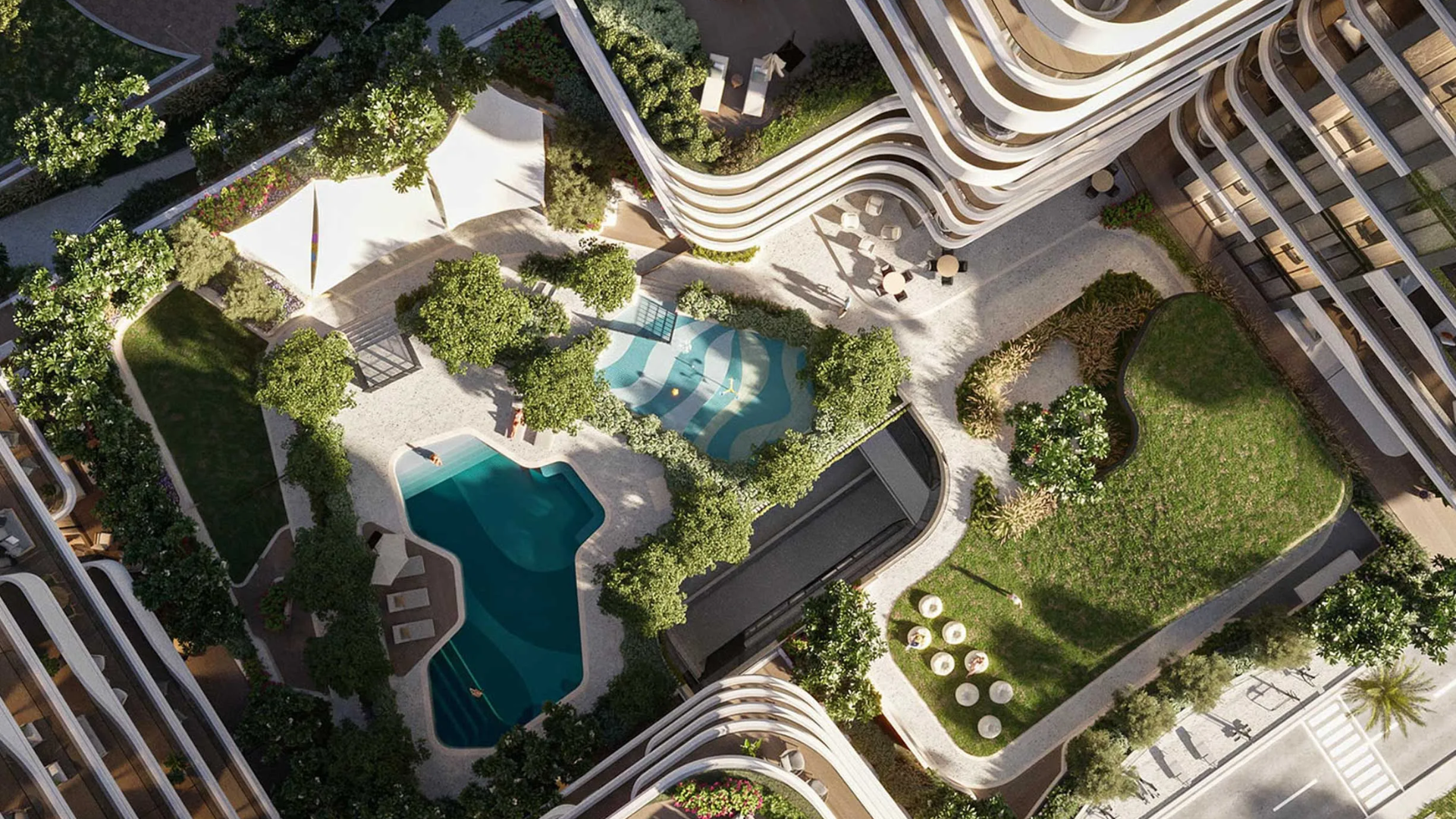 The refreshing swimming pool area with sun loungers and peaceful landscaping .