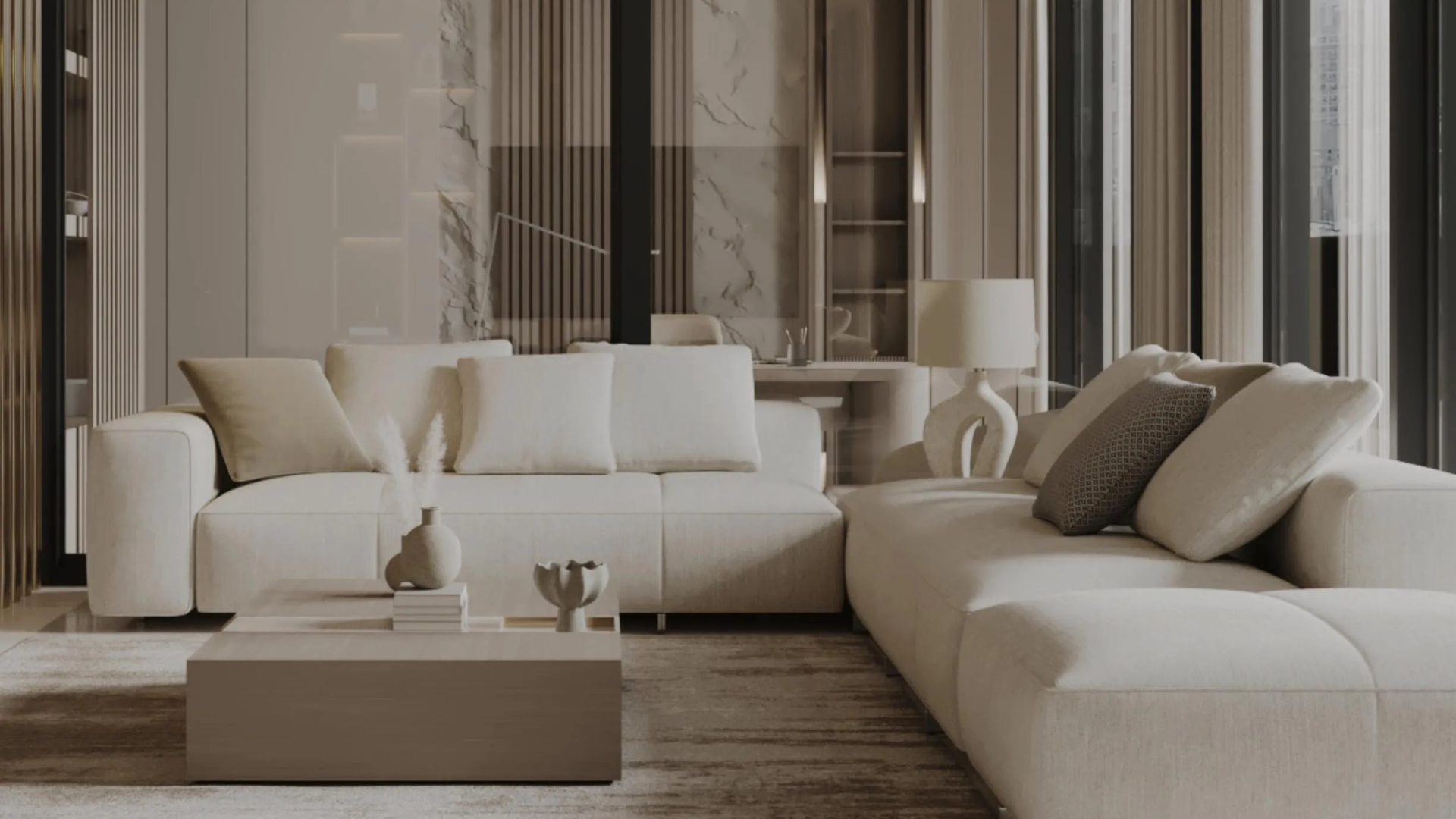 A modern living room with a large, neutral-toned sofa and minimalist furniture.