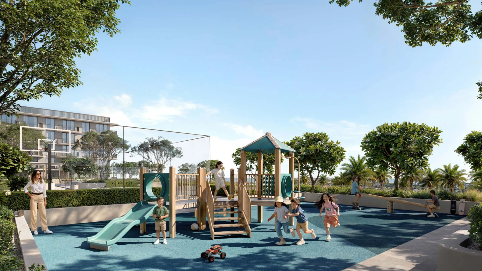 Children playing on a modern outdoor playground with slides, climbing structures, and greenery in a residential community