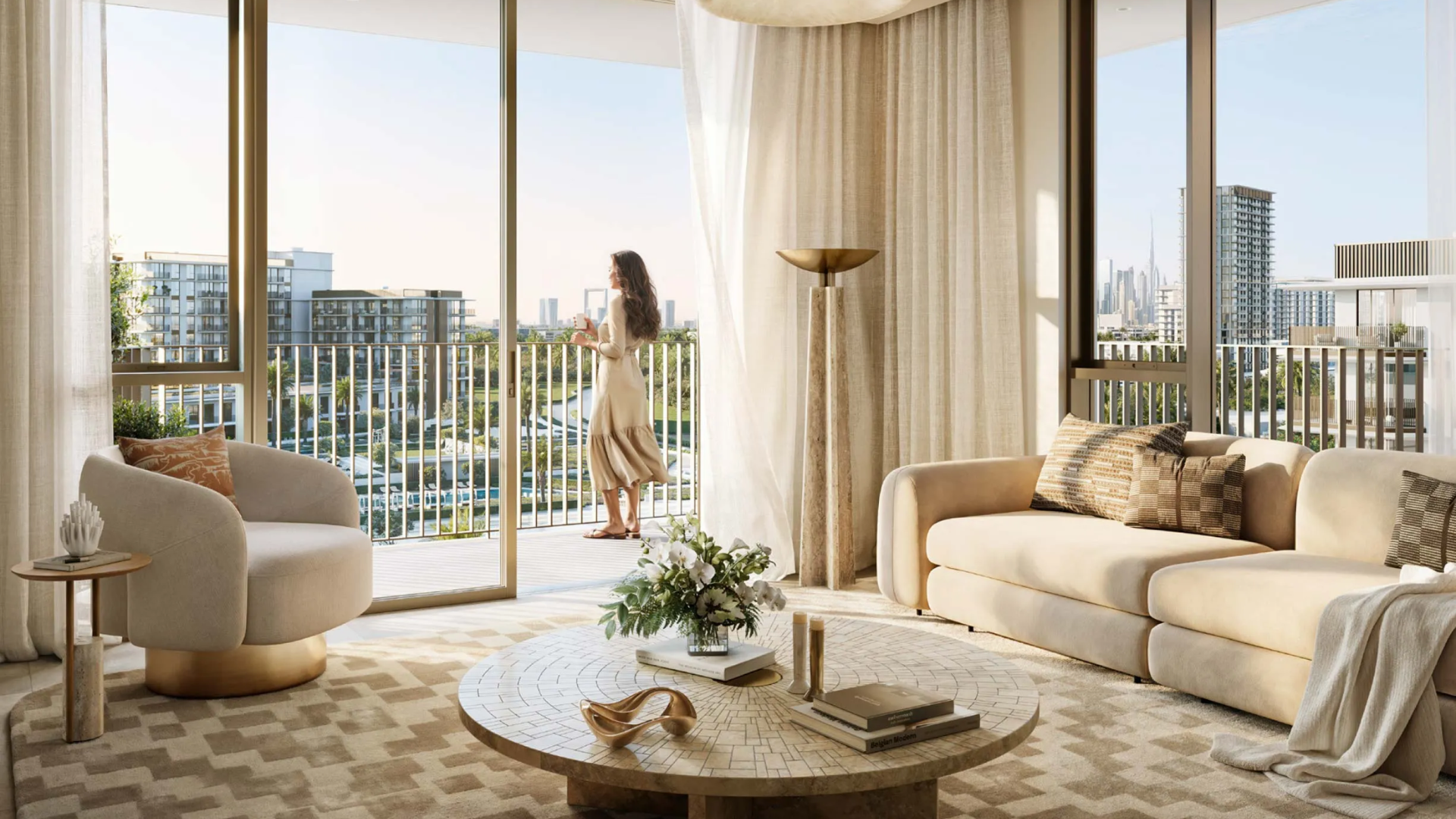 Elegant living room with sofa, armchair, and coffee table, plus a woman on the balcony enjoying city views.