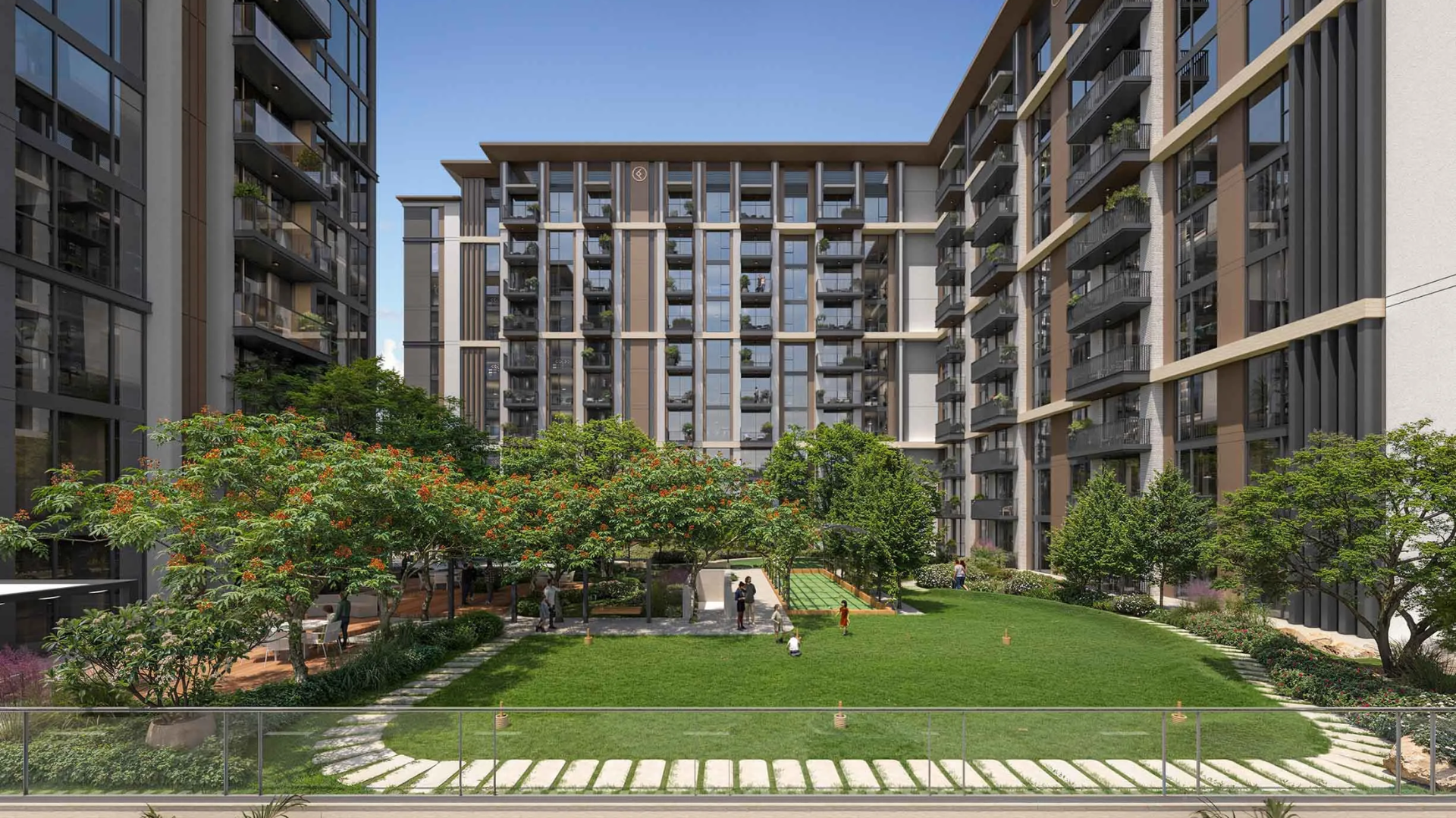 Green courtyard with lawn and seating between buildings