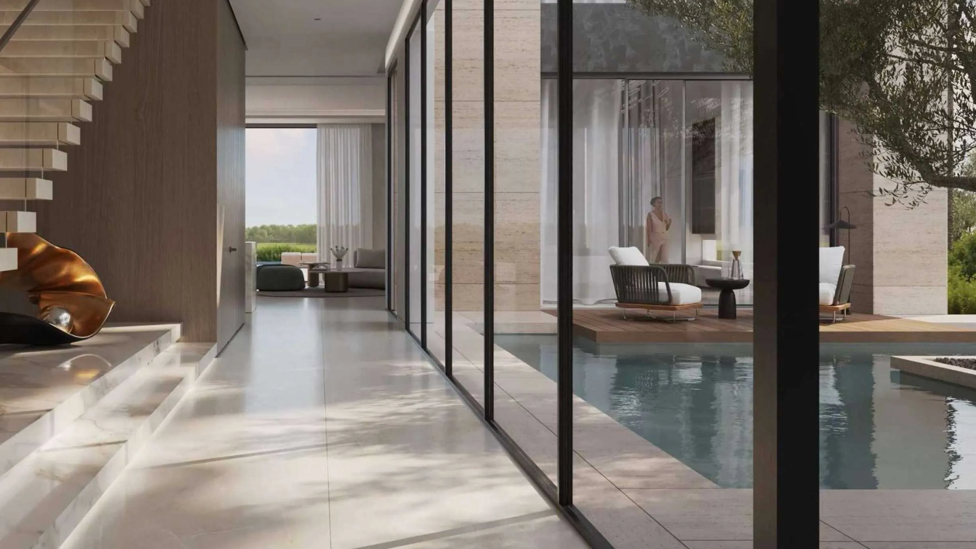 Modern villa entry hall next to an outdoor pool deck with lounge chairs and a view into the living room.