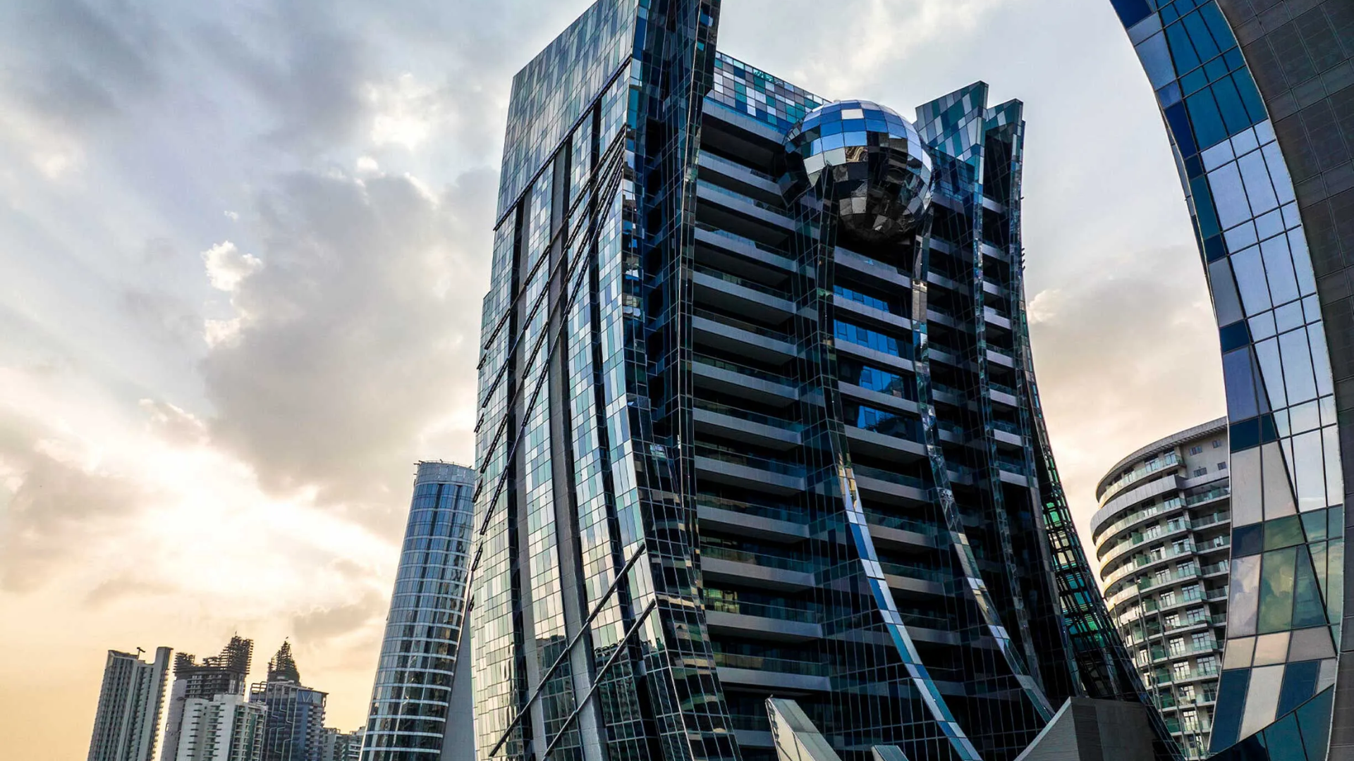 DaVinci Tower's unique architectural design in Business Bay, with a reflective sphere and glass facade.