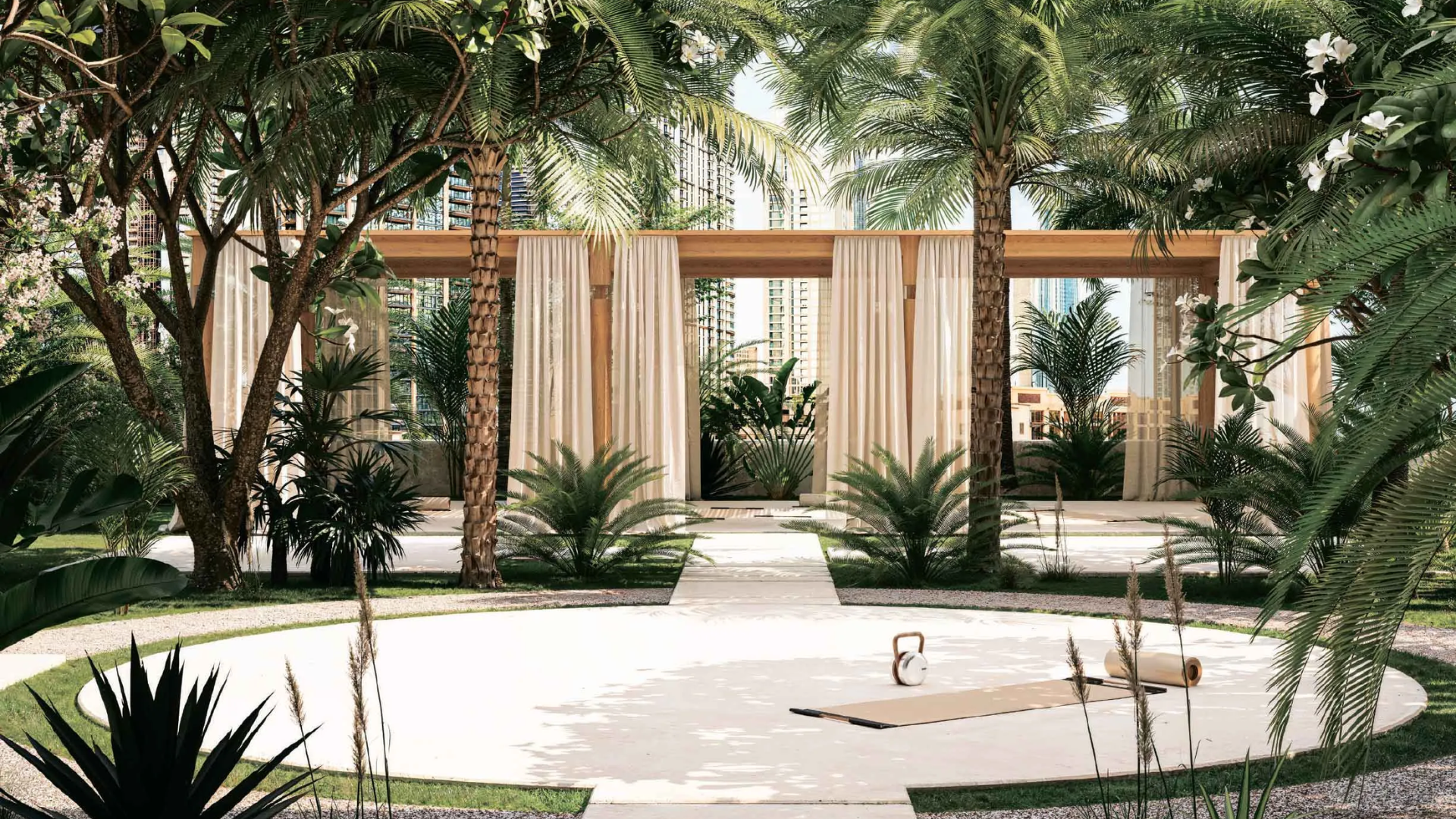 Outdoor wellness space at Elire Residences with a yoga mat, kettlebell, and a tropical garden setting.