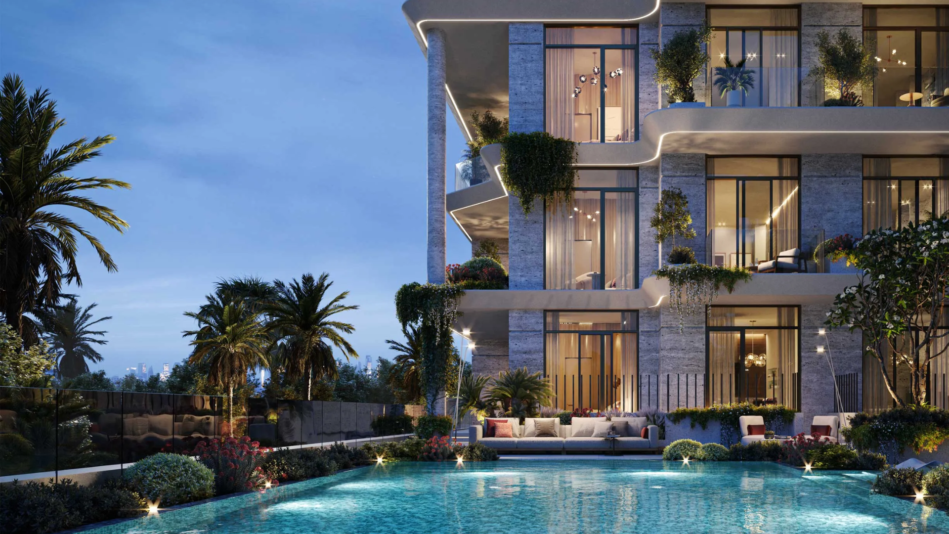 Evening view of the communal pool area , showing outdoor seating and lush landscaping.