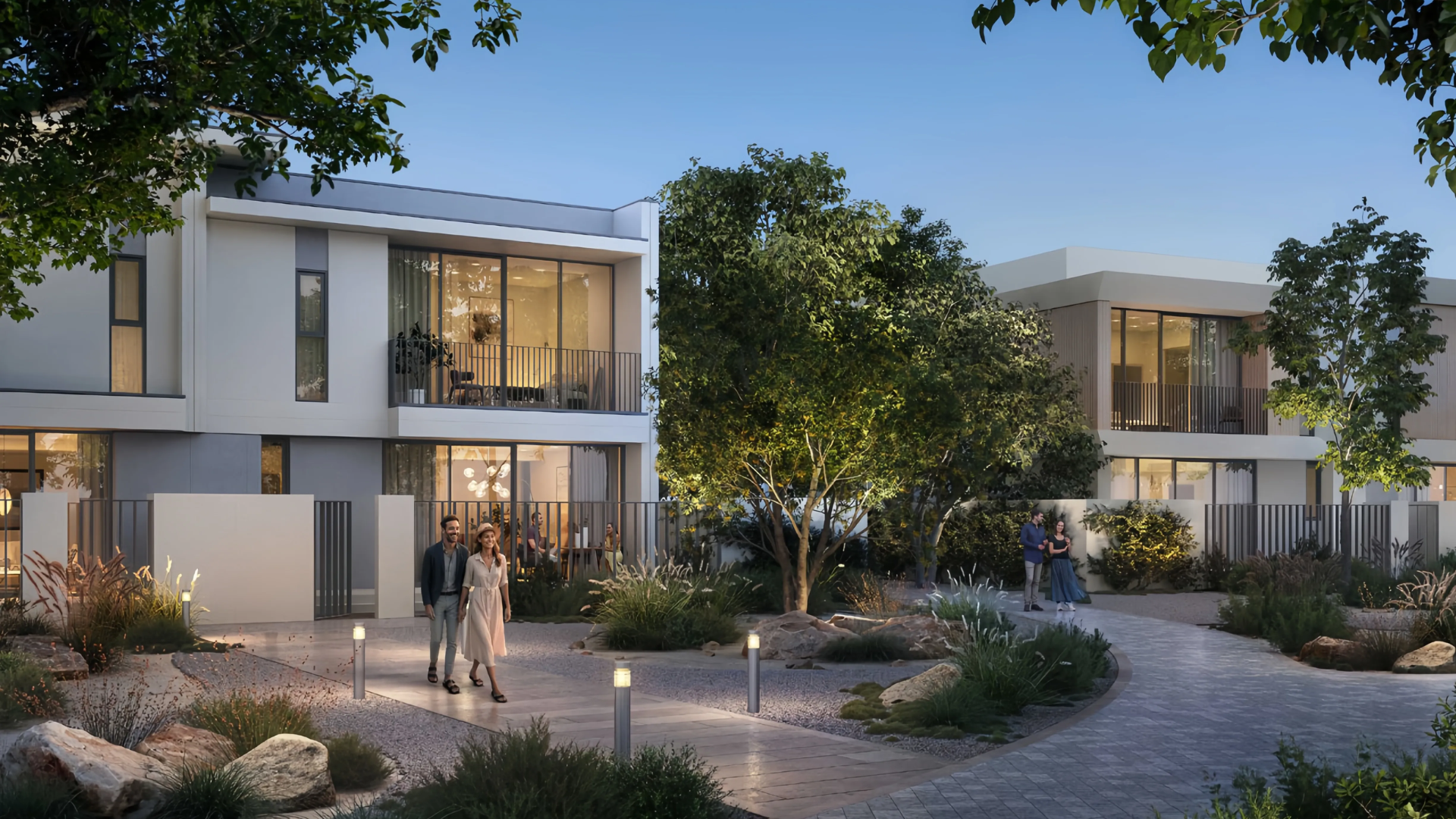 Modern two-story townhouse exterior with large windows, an integrated carport, and a small family outside.