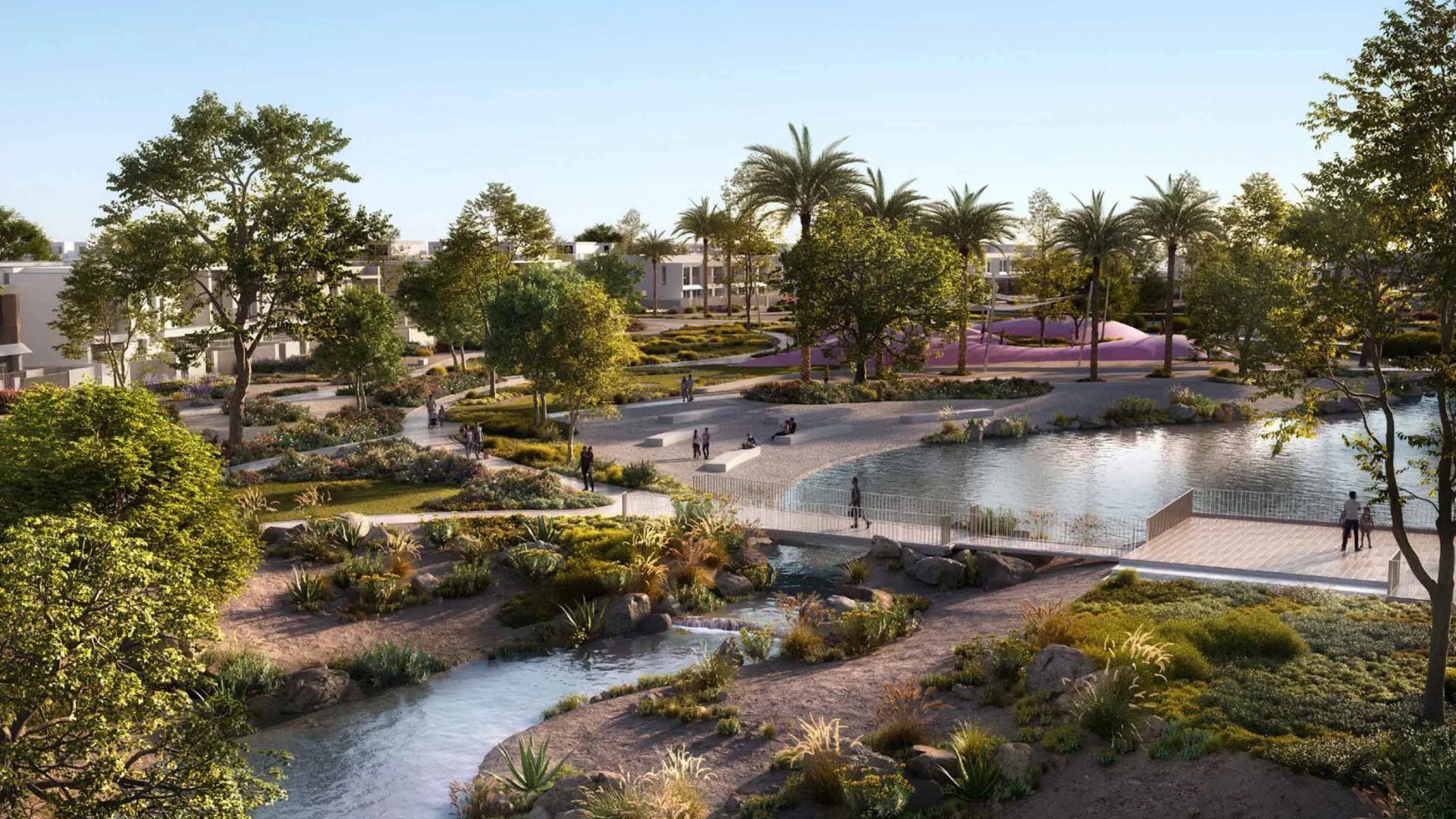 Scenic community park at Vindera at The Valley, featuring walking trails, a stream, and a pond.