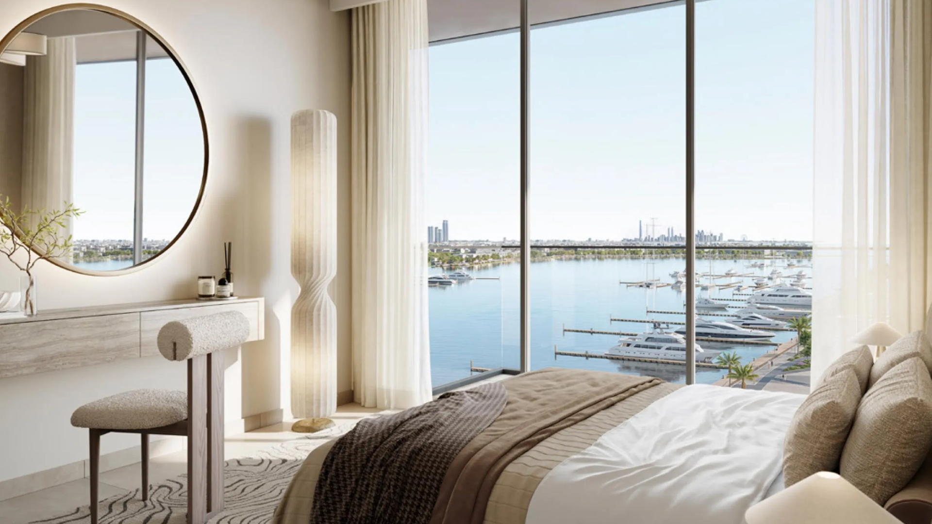A bright bedroom with floor-to-ceiling windows and a panoramic view of luxury yachts.