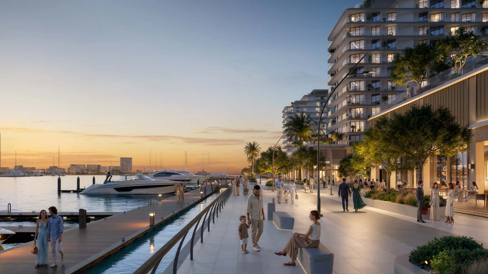 The illuminated waterfront promenade at AUREA by EMAAR, showing residents strolling along at sunset.