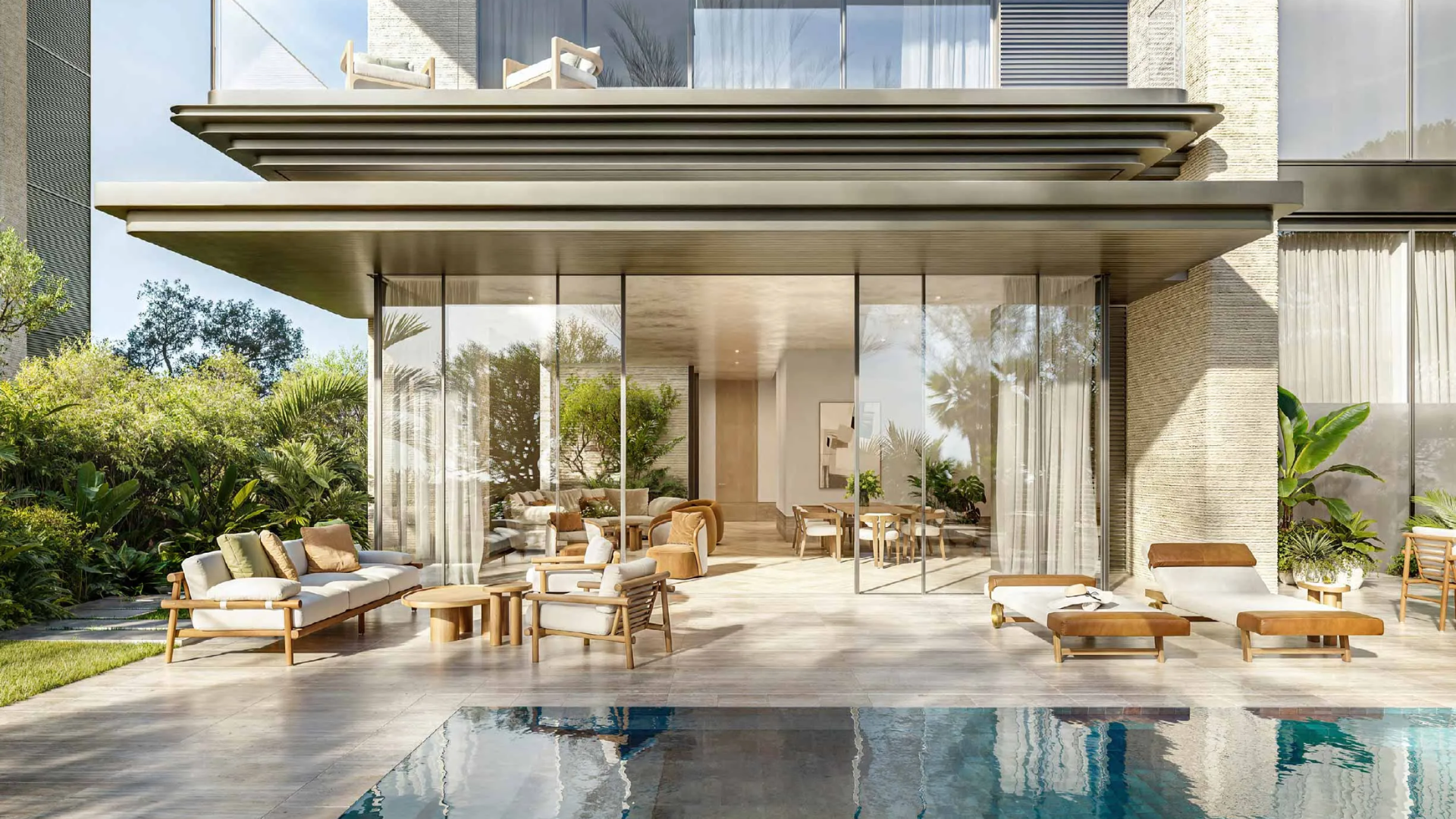 Luxury villa patio and private pool area with outdoor lounge furniture and large sliding glass doors.