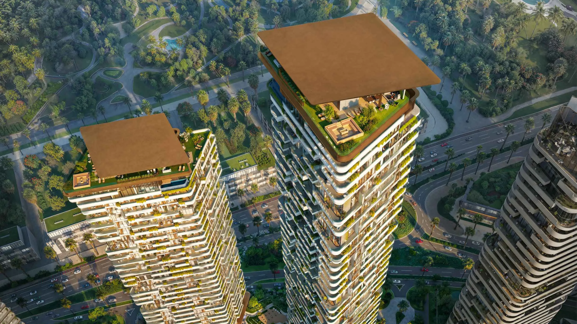 Two tall, modern skyscraper buildings illuminated at night, featuring offset balconies and a podium base.