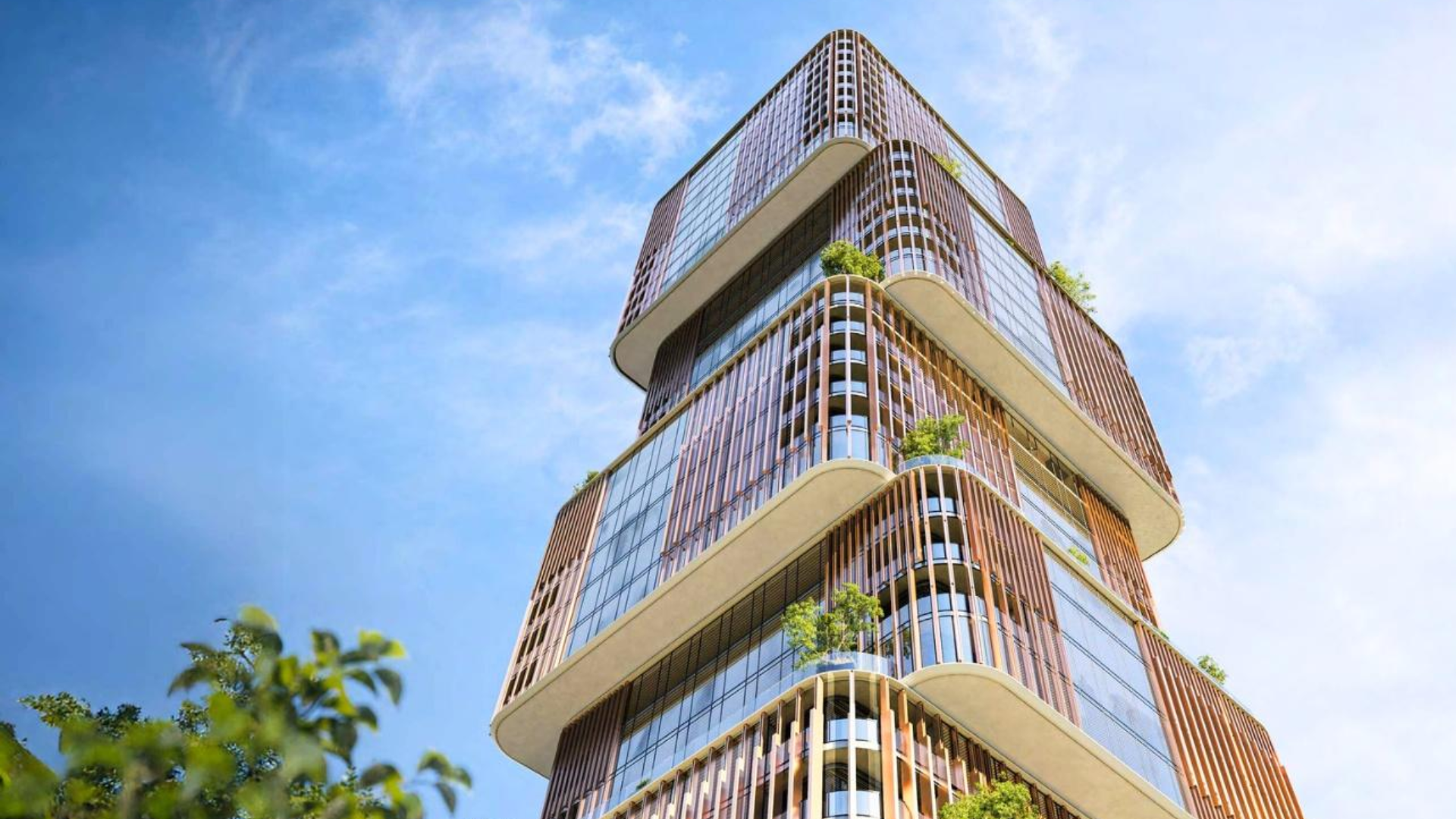 Modern high-rise building with a unique, stacked architectural design and integrated greenery under a blue sky .