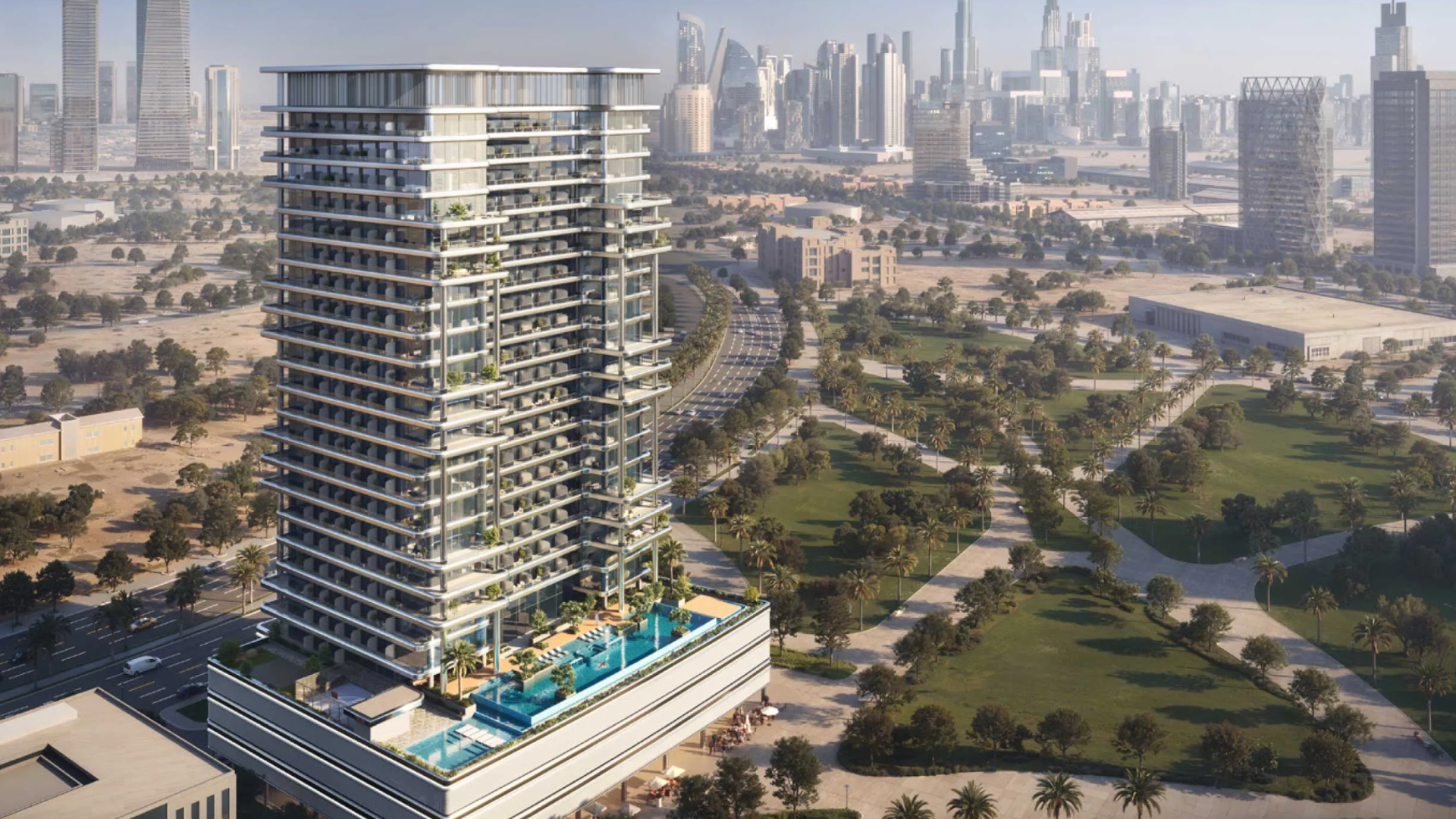 A modern high-rise tower with balconies and a podium pool overlooking green parks and a distant skyline.