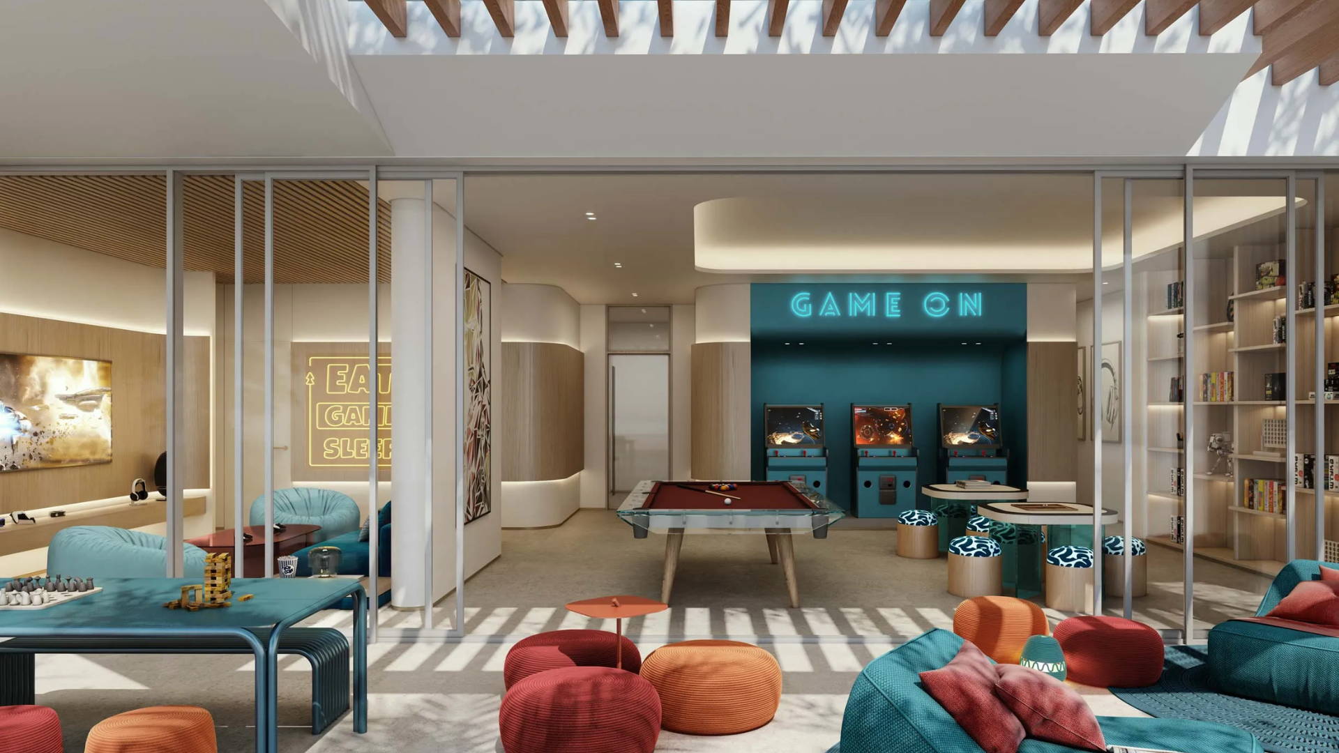 Modern indoor game room with pool table, arcade machines, lounge seating, and bookshelf under natural skylight.