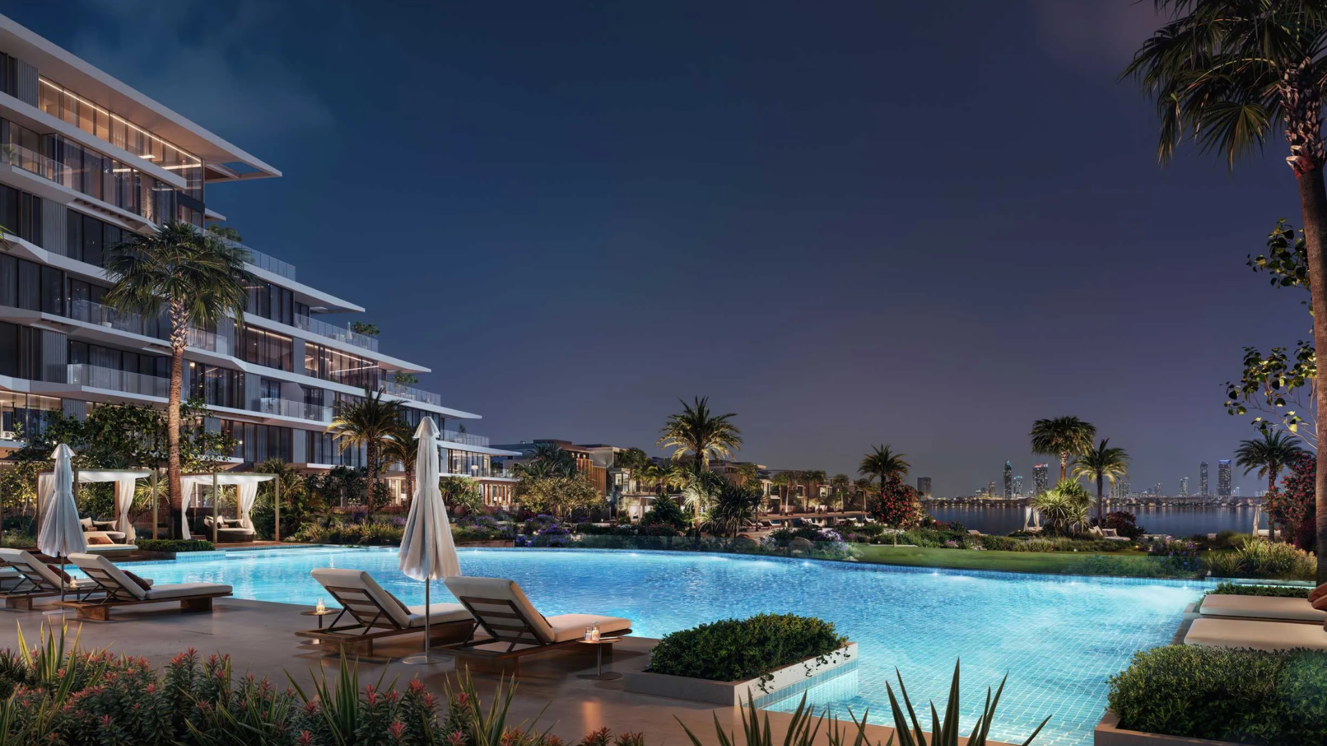 Contemporary residential complex with a terraced facade, surrounded by palm trees and an outdoor pool deck.