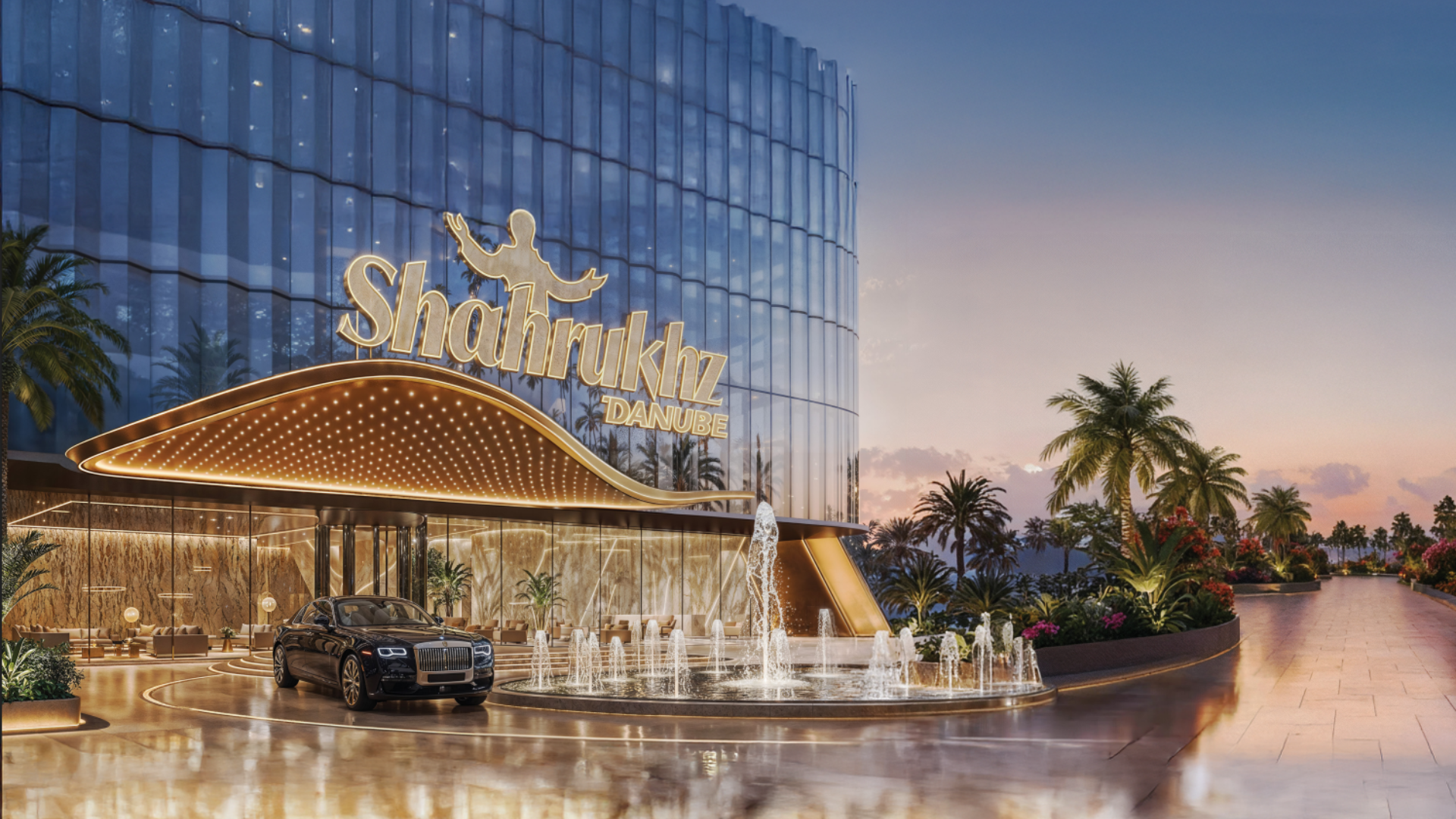 A grand luxury commercial building entrance with a curved, illuminated canopy and a prominent water fountain.