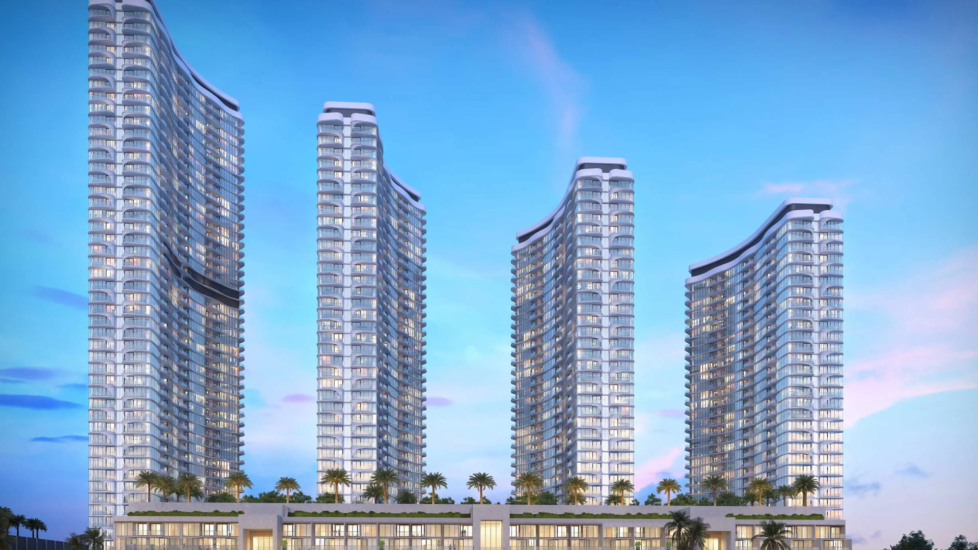 Four modern curved high-rise towers with glass façades and a landscaped podium.