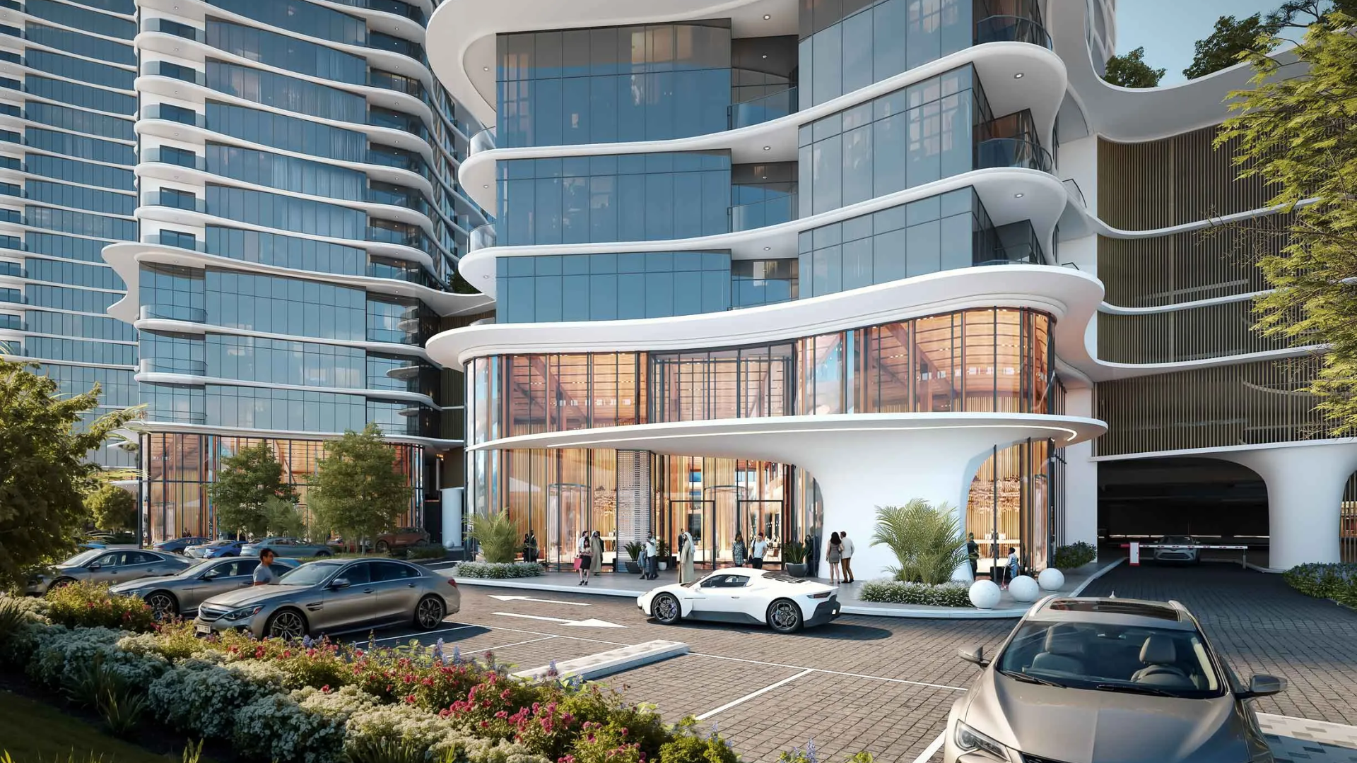 Contemporary glass-fronted building with curved balconies, a stylish entrance, and cars parked in front.